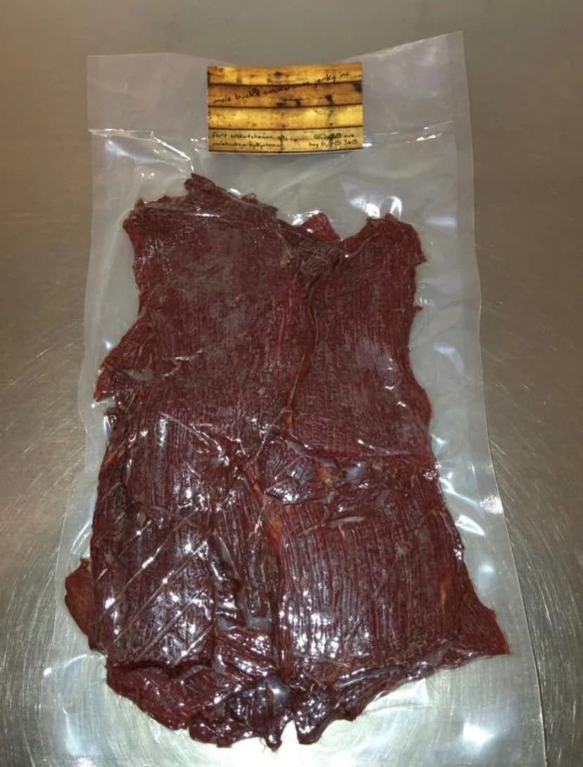 Vacuum-sealed bag of beef jerky with a hand-lettered Uncle Buck's Smokehouse Jerky label, Fort Saskatchewan